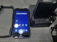 Datalogic MEMOR 10 with charger, docking cradle, protective case, and trigger.